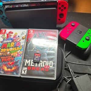 Switch Oled with: 

Mario Party
Metroid Dread
Mario 3D
Extra Joycon
128 GB SD